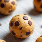 Frozen Greek yogurt peanut butter bites arranged on a parchment-lined tray.